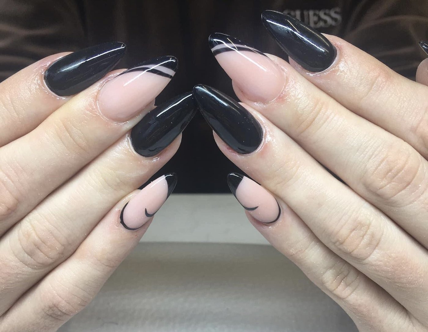 Manicure w czerni i odcieniu nude z ręcznie malowanymi liniami